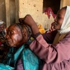 A displaced South Sudanese woman braids her grandmother's hair Jan. 15, 2026, at a shelter in El Obeid, in Sudan's North Kordofan state. In a March 26, 2026, message Italian Bishop Christian Carlassare of Bentiu, South Sudan, said his people are living a real-life Way of the Cross, marked by suffering, violence and deep wounds.(OSV News photo/El Tayeb Siddig, Reuters)
