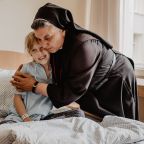 Sister Michaela Rak of the Sisters of Merciful Jesus hugs a patient in the Hospice of Blessed Michal Sopocko in an undated photo in Vilnius, Lithuania. (OSV News photo/courtesy Hospice of Blessed Michal Sopocko)