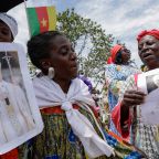 Women hold portraits of Pope Leo XIV at Yaounde Nsimalen International Airport in Yaounde, Cameroon, April 15, 2026, ahead of the pontiff's arrival to begin his apostolic journey to the African country. Late on April 13, separatist factions operating in Cameroon's Anglophone regions announced a temporary cessation of hostilities would be in place during the papal visit. (OSV News photo/Luc Gnago, Reuters)