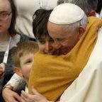 Pope Francis embraces a young woman during his general audience in the Paul VI hall at the Vatican Feb. 9, 2022. Pope Francis, formerly Argentine Cardinal Jorge Mario Bergoglio, died April 21, 2025, at age 88. (CNS photo/Paul Haring)