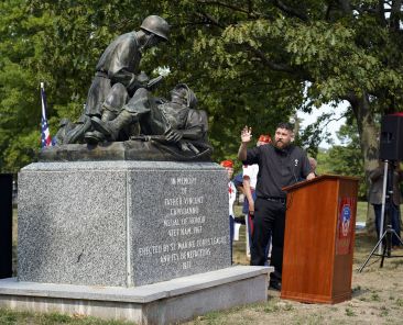 Deacon Charles Carroll blesses a monument dedicated to Maryknoll Father Vincent R. Capodanno during a memorial service marking the 55th anniversary of the priest's death at Fort Wadsworth in Staten Island, N.Y., Sept. 4, 2022. Father Capodanno, a native of Staten Island, was killed while ministering as a U.S. Navy chaplain to wounded Marines on a battlefield in Vietnam. (CNS photo/Gregory A. Shemitz)