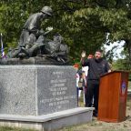 Deacon Charles Carroll blesses a monument dedicated to Maryknoll Father Vincent R. Capodanno during a memorial service marking the 55th anniversary of the priest's death at Fort Wadsworth in Staten Island, N.Y., Sept. 4, 2022. Father Capodanno, a native of Staten Island, was killed while ministering as a U.S. Navy chaplain to wounded Marines on a battlefield in Vietnam. (CNS photo/Gregory A. Shemitz)