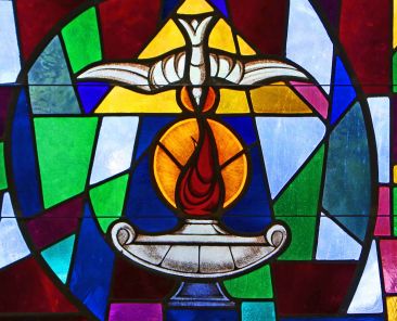 The Holy Spirit and a lantern flame symbolizing the sacrament of confirmation are depicted in a stained-glass window at Sts. Cyril & Methodius Church in Deer Park, N.Y. Think of the responsorial psalm for Pentecost Sunday: "Lord, send out your Spirit and renew the face of the earth." (CNS photo/Gregory A. Shemitz)
