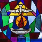 The Holy Spirit and a lantern flame symbolizing the sacrament of confirmation are depicted in a stained-glass window at Sts. Cyril & Methodius Church in Deer Park, N.Y. Think of the responsorial psalm for Pentecost Sunday: "Lord, send out your Spirit and renew the face of the earth." (CNS photo/Gregory A. Shemitz)