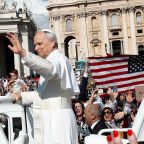 An American flag is displayed as Pope Leo XIV, formerly Cardinal Robert F. Prevost, waves as he arrives to celebrate his inauguration Mass at the Vatican May 18, 2025. He is the first American pope in history. (OSV News photo/Andy Abeyta, Reuters)