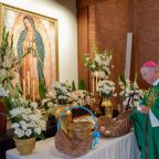 Phoenix Bishop John P. Dolan places a carnation before Our Lady of Guadalupe, the diocese’s patron saint, at the first annual Mass of Remembrance for Those Who Have Died by Suicide on Sept. 4, 2022, at Ss. Simon and Jude Cathedral in Phoenix. Family and friends were given a carnation -- one for each victim -- and lined up to place the flowers before the cathedral’s side altar. Names of the loved ones also appeared in a book before the altar. (OSV News photo/Brett Meister, courtesy Diocese of Phoenix)