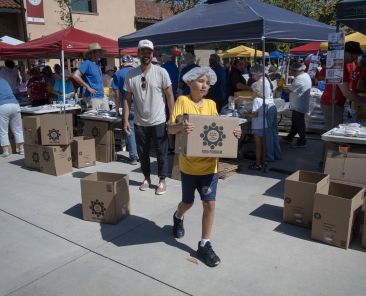 A volunteer helps move boxes of packaged dried food June 13, 2026, during the Million Meal Event at Cathedral Catholic High School in San Diego. Over the course of two days, approximately 5,100 people, mostly from San Diego-area Catholic parishes, assembled 2 million packages of red lentils, rice, dried vegetables and vitamins to be distributed to needy communities within the San Diego Diocese as well as in neighboring Tijuana, Mexico. (OSV News photo/David Maung)