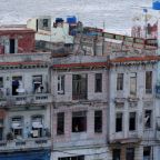 People stand on their balconies in Havana during a blackout June 17, 2026. The Cuban government on June 18 announced far-reaching economic measures that could mark the most significant shift toward a market economy since the 1959 revolution. (OSV News photo/Norlys Perez, Reuters)