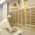 Pope Leo XIV lays flowers before a memorial for staff members of the United Nations' World Food Program who lost their lives in service, at the WFP headquarters in Rome June 22, 2026. World hunger has only worsened as conflicts in the world take priority over human lives and weaponry is allowed more distribution than basic humanitarian needs, the pope told members gathered for an address. (OSV News photo/Simone Risoluti, Vatican Media)