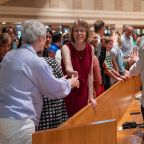 Parishioner give the sign of peace before receiving the Eucharist during Communion at the 50th Anniversary Mass for St. Joseph Catholic Church, on June 06, 2026 at the parish in Richardson.