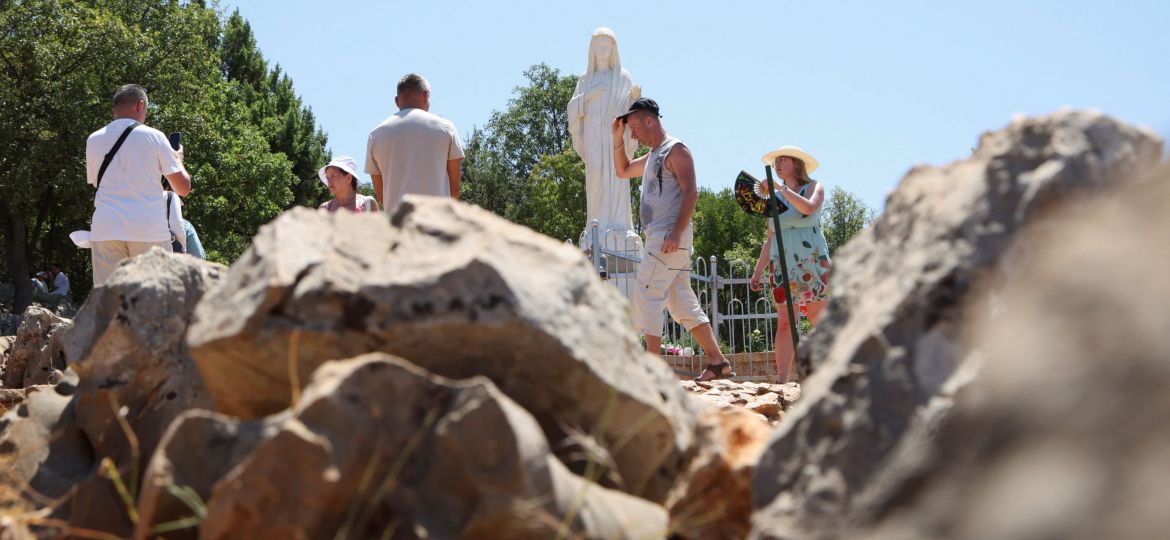 PILGRIMS PRAY MEDJUGORJE MARY STATUE