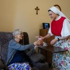 An undated file photo shows a Dominican Sister of Hawthorne serving a resident at Rosary Hill Home in New York. On July 30, 2026, a judge temporarily shielded four orders of women religious and Catholic healthcare ministries from enforcement of a New York state law allowing physicians to aid terminally ill adults in dying by suicide. (OSV News photo/courtesy Becket)