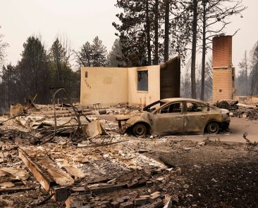 A burned vehicle sits amid the remains of a destroyed home as wildfires burn in Spokane, Wash., Aug. 2, 2026. Wildfires in eastern Washington state forced the evacuation of 60,000 people in the Spokane area while destroying at least 600 homes, businesses and other structures, authorities said Aug.2. (OSV News photo/David Ryder, Reuters)