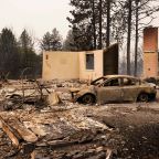 A burned vehicle sits amid the remains of a destroyed home as wildfires burn in Spokane, Wash., Aug. 2, 2026. Wildfires in eastern Washington state forced the evacuation of 60,000 people in the Spokane area while destroying at least 600 homes, businesses and other structures, authorities said Aug.2. (OSV News photo/David Ryder, Reuters)