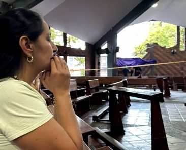 A woman prays inside a Catholic church that was damaged during an earthquake, in Cali, Colombia, Aug. 10, 2026. The Catholic bishops of Colombia are calling for national unity and urgent aid after the 7.4-magnitude earthquake struck the country, killing at least 132 people and injuring over 570. (OSV News photo/Marco Trujillo, Reuters) Editors: Picture taken with a mobile phone.