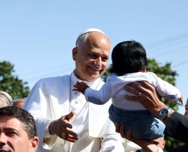 Pope Leo XIV smiles at a child at the Plaza del Cristo de La Laguna, Tenerife, Canary Islands, Spain, June 12, 2026, on the day he meets with migrants and humanitarian organizations. On Aug. 14, the Vatican published Pope Leo XIV's message for the World Day of Migrants and Refugees which reflects on the theme: "Even Just One of These Children." (OSV News photo/Yara Nardi, Reuters) PLEASE INCLUDE REUTERS IN THE CREDIT