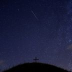 A meteor streaks past stars in the night sky in Grossmugl, Austria, Aug. 13. (CNS photo/Heinz-Peter Bader, Reuters)