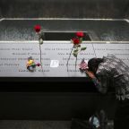 A woman grieves at the inscription of her late husband's name at the national 9/11 Memorial and Museum in New York City Sept. 11, 2014. Twenty-five years after the 9/11 terrorism attacks that claimed the lives of nearly 3,000 people, Catholic family members who lost loved ones that day have credited their faith with getting through the losses. (OSV News photo/Chang Lee, Reuters)