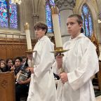 Altar servers Dominic and his older brother, Vincenzo, carry candles in procession for the 2025 Archdiocese of Newark’s Jubilee Mass for Catholic Schools at the Cathedral Basilica of the Sacred Heart in Newark. (OSV News photo/courtesy Archdiocese of Newark)