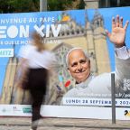 A woman walks past a poster in front of the train station in Metz, France, Sept. 9, 2026, welcoming Pope Leo XIV ahead of his visit in the northeastern French city. Pope Leo will make an official apostolic journey to France Sept. 25-28. (OSV News photo/Ardee Napolitano, Reuters)