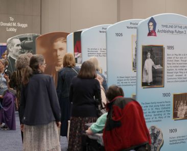 Pilgrims look at an exhibit of Venerable Fulton J. Sheen ahead of the beatification Mass for Archbishop Sheen Sept. 24, 2026, at The Dome at America's Center in St. Louis. The archbishop is remembered as one of the most influential and innovative evangelists in American history. (OSV News photo/Bob Roller)