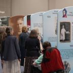 Pilgrims look at an exhibit of Venerable Fulton J. Sheen ahead of the beatification Mass for Archbishop Sheen Sept. 24, 2026, at The Dome at America's Center in St. Louis. The archbishop is remembered as one of the most influential and innovative evangelists in American history. (OSV News photo/Bob Roller)