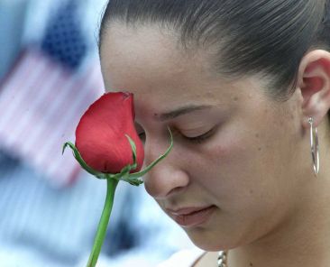 A woman pauses during a moment of reflection during the 2001 "Prayer for America" service held at Yankee Stadium in New York Sept. 23, 2003. Twenty-five years after the 9/11 terrorism attacks that claimed the lives of nearly 3,000 people, Catholic family members who lost loved ones that day have credited their faith with getting through the losses. (OSV News photo, Shaun Best, Reuters)