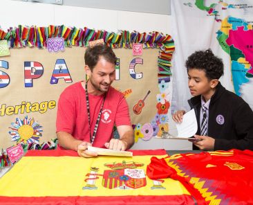 Spanish teacher Ana Davila directs the Hispanic Heritage Project in which students and teachers participate in at St. Philip and St. Augustine School in Dallas. Coach Angel Batanero who is from Spain is interviewed by student Axl Mateo.