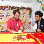 Spanish teacher Ana Davila directs the Hispanic Heritage Project in which students and teachers participate in at St. Philip and St. Augustine School in Dallas. Coach Angel Batanero who is from Spain is interviewed by student Axl Mateo.