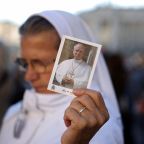 A nun holds an image of Pope Leo XIV as Cardinal Luis Antonio Tagle, pro-prefect of the Dicastery for Evangelization, celebrates a Mass in St. Peter's Square at the Vatican Oct. 14, 2026, on the final day of a meeting in which the presidents of bishops' conferences are marking the 10th anniversary of "Amoris Laetitia" ("The Joy of Love"). The Mass also included special prayers for the health of Pope Leo XIV, following his lung surgery the previous day and diagnosis of cancer. (OSV News photo/Stoyan Nenov, Reuters)