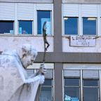 A sign that reads "Hematology greets the Pope!" is seen below a window of a clinic at Rome's Gemelli Hospital Oct. 15, 2026, near the statue of St. John Paul II. The sign went up after the Vatican said Pope Leo XIV had been diagnosed with cancer following surgery Oct. 13 to remove part of his right lung. (OSV News photo/Stoyan Nenov, Reuters)