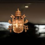 The papal coat of arms of Pope John Paul II is displayed on a vehicle during the inauguration of the exhibition "A Century of Popemobiles" at the Vatican Museums Oct. 28, 2026. (CNS photo/Lola Gomez)